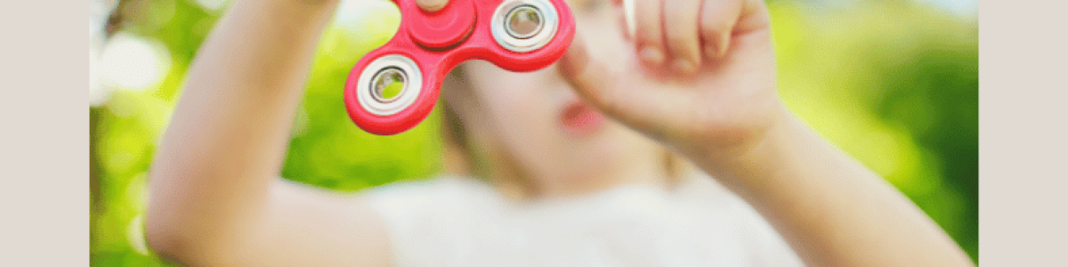 Child with ADHD playing with fidget toy